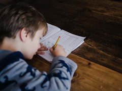 boy doing homework in a living room