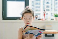 oung girl reading workbook